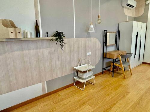 a kitchen with a counter and a table and a chair at Kuantan Imperium by Glex in Kuantan