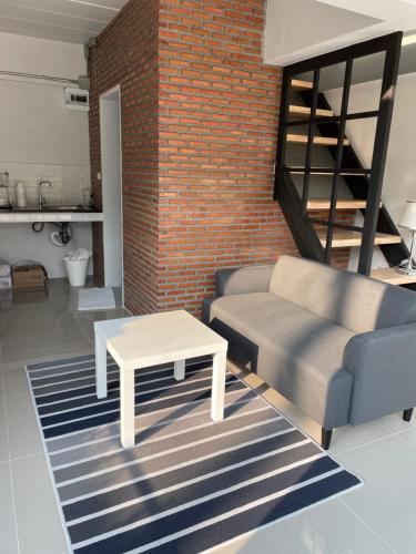 a living room with a couch and a coffee table at Sealoft,Pattaya in Bang Lamung