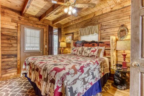 a bedroom with a bed in a room with wooden walls at A Waterfall Retreat- Waterfall, Cozy Cabin Retreat in the Smokies Comfort & Fun for All in Sevierville