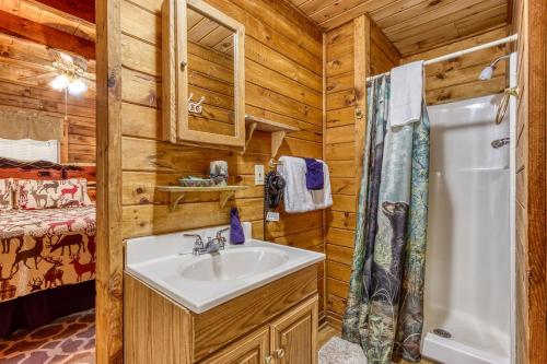 a bathroom with a sink and a shower in a cabin at A Waterfall Retreat- Waterfall, Cozy Cabin Retreat in the Smokies Comfort & Fun for All in Sevierville