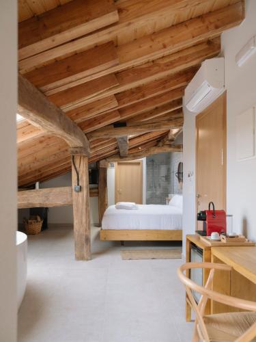 a bedroom with a bed and wooden ceilings at Hotel Nafarrola - Gastronomy & Wine in Bermeo