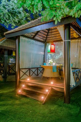 a gazebo with a table and a lamp at Hotel Royal Orchid Bangalore in Bengaluru