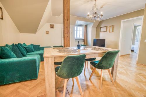 a living room with a green couch and a table at Historic Residence Apartments at Old Town in Tallinn