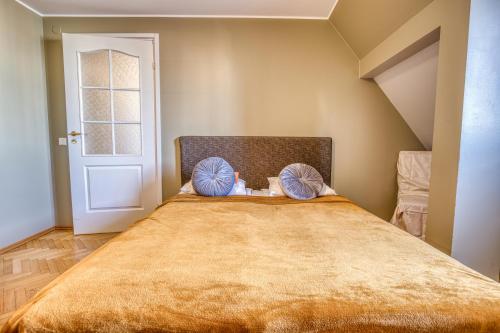 a bedroom with a large bed with blue pillows at Historic Residence Apartments at Old Town in Tallinn