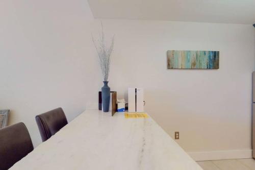 a white dining room table with chairs and a painting at Little Harbor Resort #510 Tampa Bay FL Beach, Hot Tub, Pools in Ruskin