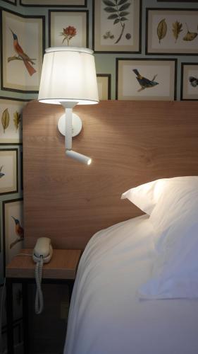 Katil atau katil-katil dalam bilik di Logis Hôtel & Restaurant - Le Saint-Louis
