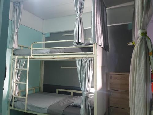 two bunk beds in a room with a window at i-smile in Chiang Mai
