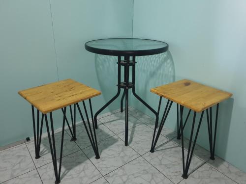 two tables and a glass table and two stools at i-smile in Chiang Mai
