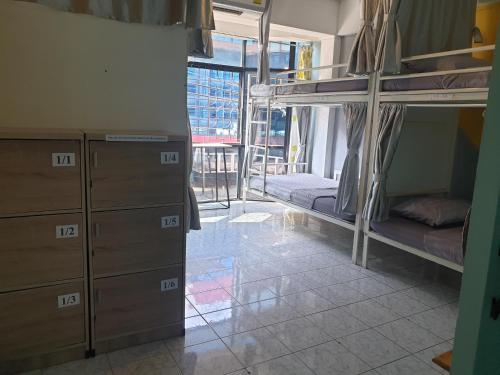 a dorm room with bunk beds and a window at i-smile in Chiang Mai