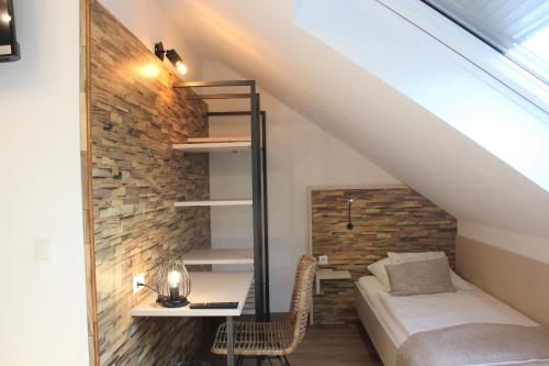 a bedroom in a loft with a bed and a desk at Am Blumenhaus in Bamberg
