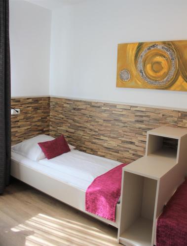 a bedroom with a bed with a brick wall at Am Blumenhaus in Bamberg