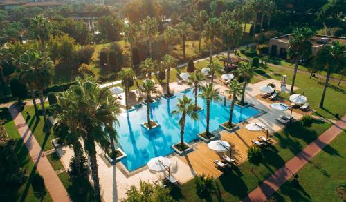 an overhead view of a large swimming pool with palm trees at IC Hotels Residence in Lara