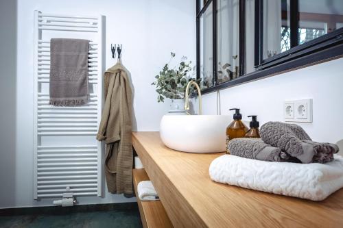 a bathroom with a sink on a wooden counter at Der Steinerwirt - hangout & hotel in Lofer