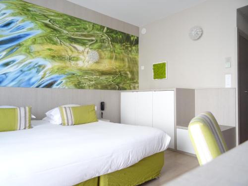 a bedroom with two beds and a painting on the wall at Domaine de la Petite Isle - Luberon in L'Isle-sur-la-Sorgue