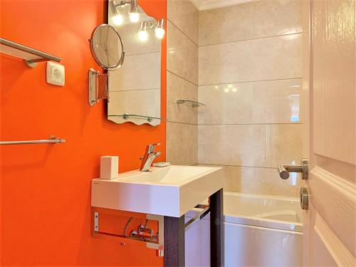 a bathroom with a sink and a mirror and a shower at Charming Calheta Plaza Penthouse in Calheta