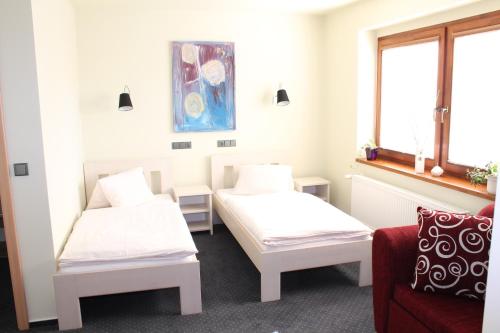 a room with two beds and a couch at Apart Hotel Jablonec in Jablonec nad Nisou