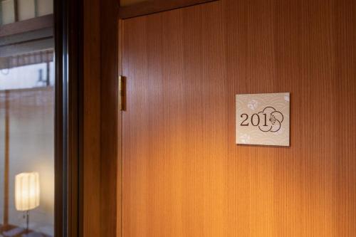 a door with a sign that says on it at 祇園の宿 杏花 in Kyoto