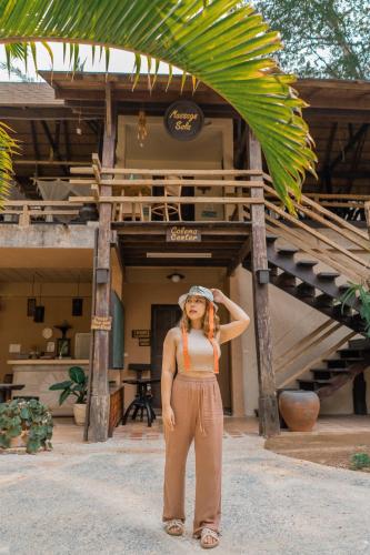 a woman wearing a hat standing in front of a building at The Spa Koh Chang Resort in Ko Chang