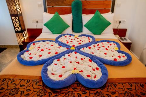 two cakes in heart shapes on a bed at Olympus Plaza Hotel in Haputale