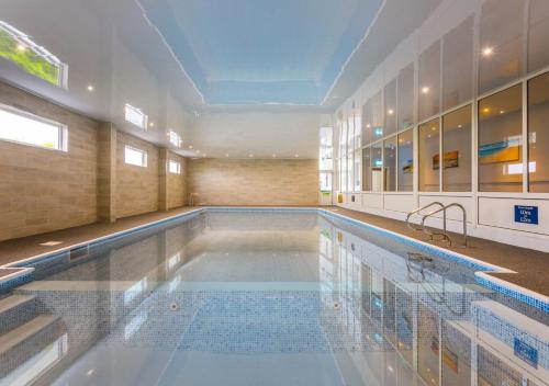 a large swimming pool in a large building at Kinloch Hotel, Isle of Arran in Blackwaterfoot