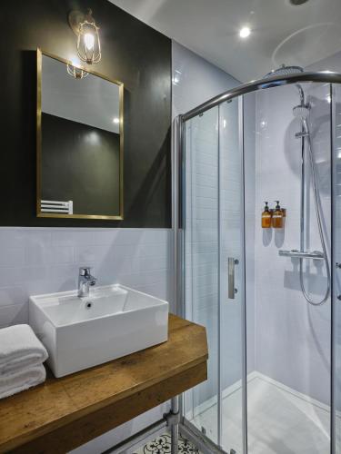 a bathroom with a sink and a shower at The Bath Hotel in Lynmouth