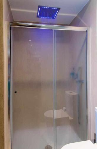 a bathroom with a glass shower and a toilet at Casa das Pesqueiras in Melgaço