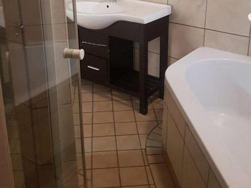 a bathroom with a sink and a shower at Country Blue Luxury Guest House in Polokwane
