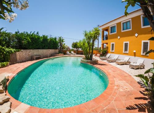 a swimming pool in front of a villa at Moonshine Guest House with private studios and private cottage in Lagos