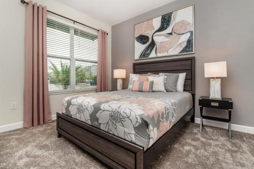 a bedroom with a bed and a window at Villa wPrivate Pool &Themed Rooms, near Disney in Kissimmee