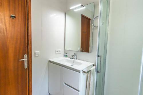 a bathroom with a sink and a mirror at Beachhouse Sa Barca in Cala Santanyi