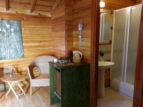 a bathroom with wooden walls and a sink and a table at Portalimo Lodge Hotel - Adult Only +12 in Cıralı