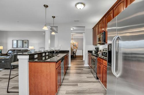 a kitchen with wooden cabinets and stainless steel appliances at 4816 Cayview Ave #306 in Orlando
