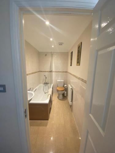 a bathroom with a tub and a sink and a toilet at Quiet town house by the sea in Broadstairs