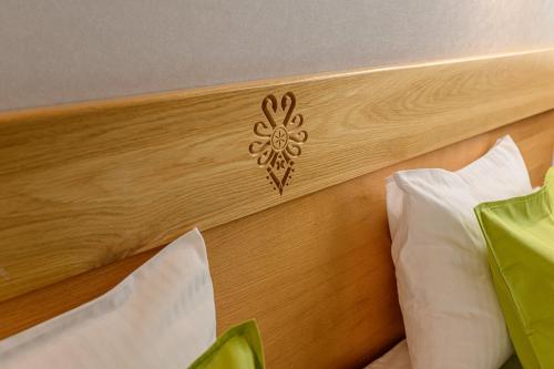 a wooden headboard of a bed with white pillows at Hotel Bachledówka in Zakopane
