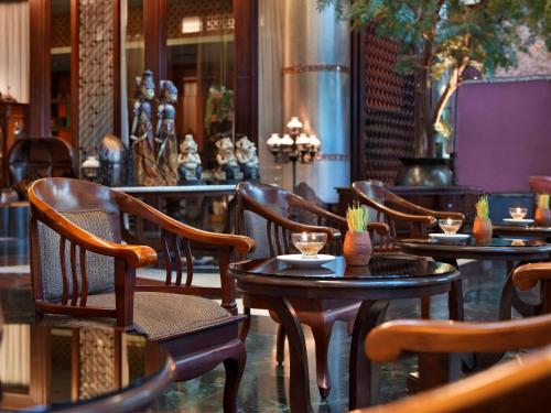 a group of tables and chairs in a restaurant at The Royal Surakarta Heritage - Handwritten Collection in Solo