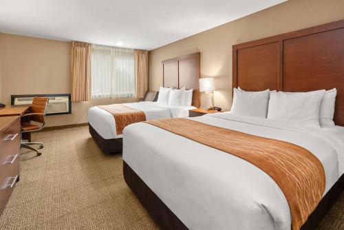 a hotel room with two beds and a desk at Comfort Inn & Suites Beaverton - Portland West in Beaverton