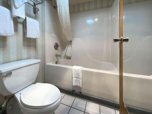 a bathroom with a toilet and a bath tub at Quality Inn & Suites North Gibsonia in Gibsonia