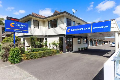 un edificio con un cartel que lee posada confort en Comfort Inn Kauri Court en Palmerston North