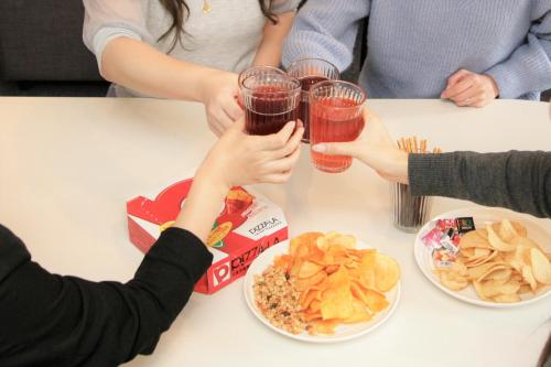 a group of people sitting at a table with drinks at goom Hotel Nakasu in Fukuoka