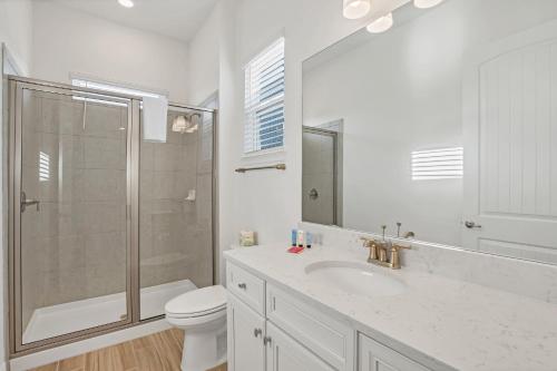 a bathroom with a shower and a toilet and a sink at Gorgeous Margaritaville Cottage wPrivate Patio in Orlando