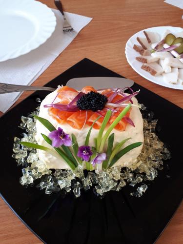 a cake on a black plate on a table at Dniprovski Zori in Kremenchuk