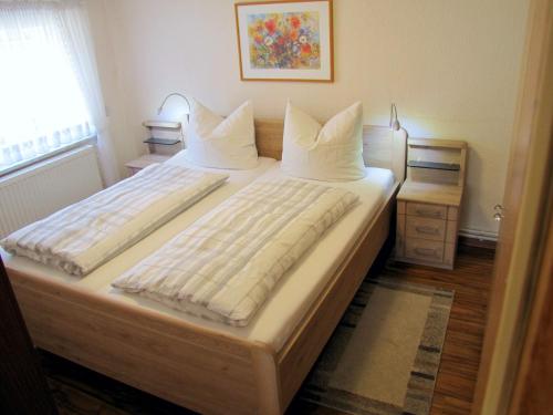 een slaapkamer met 2 bedden en witte kussens bij Ferienwohnung Schade in Hohnstein