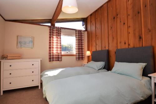 a bedroom with a bed and a window in it at Musselshell Lodge in Otter Ferry