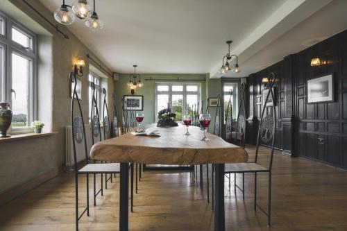 a dining room with a table and two glasses of wine at Lyth Valley Country House in Kendal