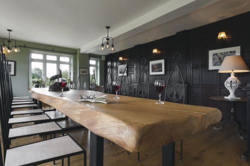 a dining room with a long table with glasses of wine at Lyth Valley Country House in Kendal