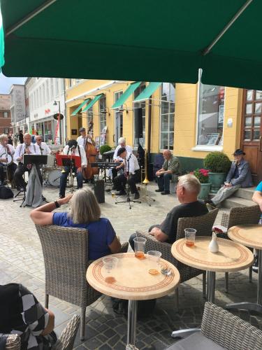 a group of people sitting at tables in a cafe at Hotel Dania in Silkeborg