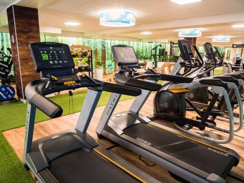 a gym with treadmills and elliptical machines at Best Western Hotel Slenaken in Slenaken