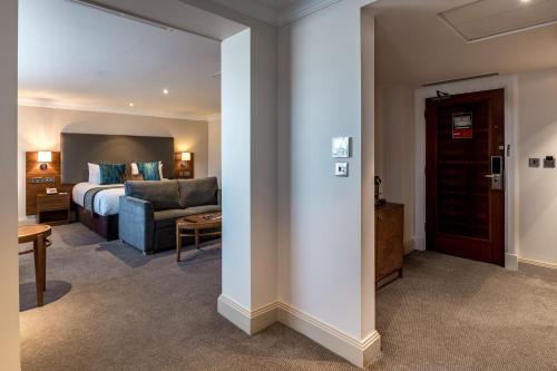 a living room with a bed and a couch at The Marble Arch Hotel, by Thistle in London