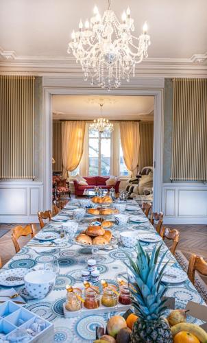 einen langen Tisch mit Essen auf einem Zimmer in der Unterkunft Le Château des Tourelles en Vendée in La Gaubretière