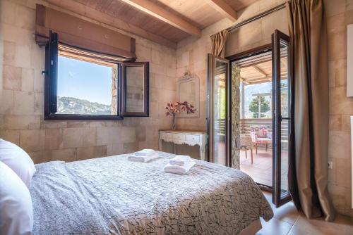 a bedroom with a bed with two towels on it at Pezoulia in Selakano